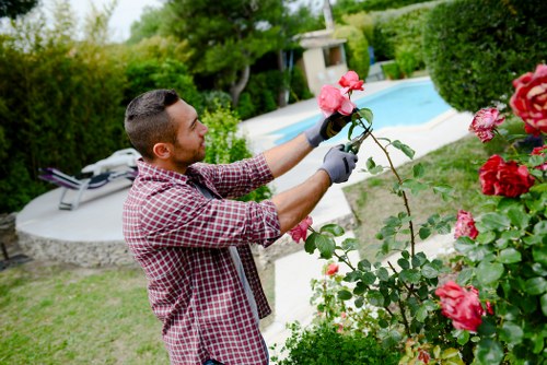 Gardeners working in a maintained UK garden setting